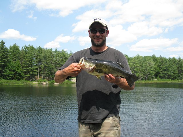 Lodge Guys Week 2011 072.JPG - Here's a picture of a Largemouth caught on Lake Wah Wash Kesh near Parry Sound.